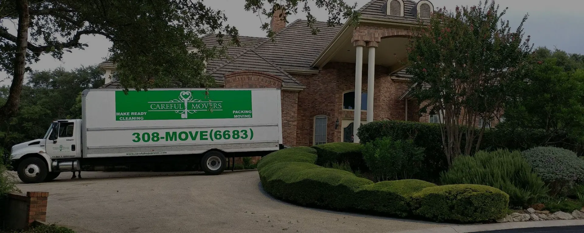 A Careful Movers truck parked in the driveway of a San Antonio home